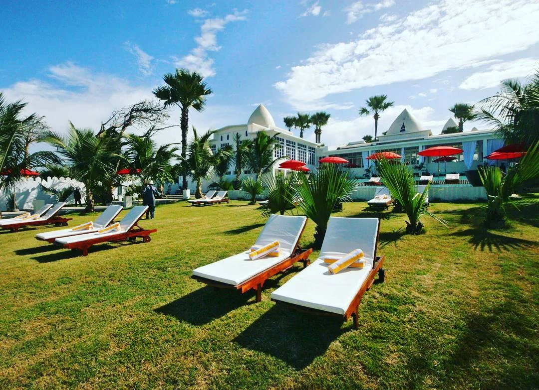 Coco Ocean tropical garden with sunbeds and white Moroccan resort