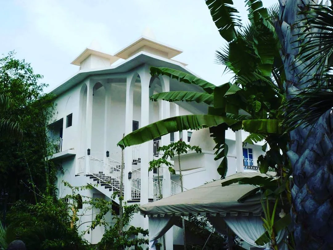 Coco Ocean white resort building surrounded by tropical garden
