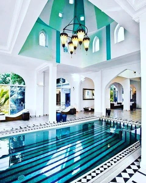Spa pool with arched columns and teal ceiling
